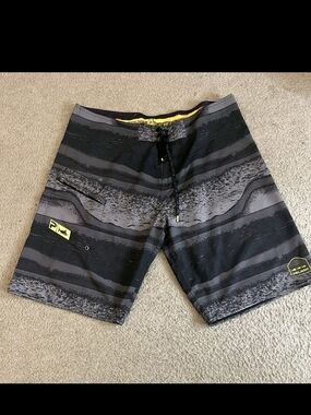 Pelagic Black and Gray Striped Board Shorts with Yellow Accents